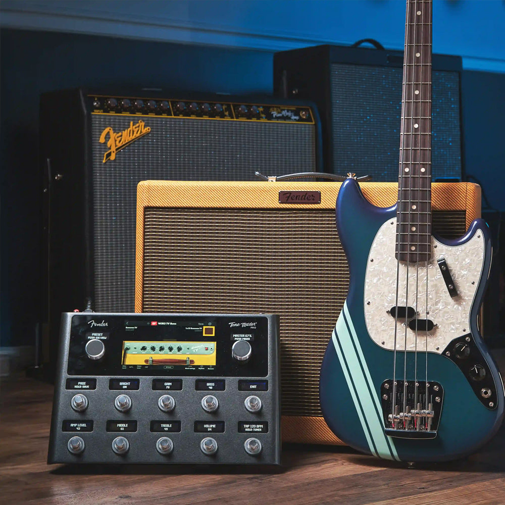 Fender guitar next to Fender amps and effects gear