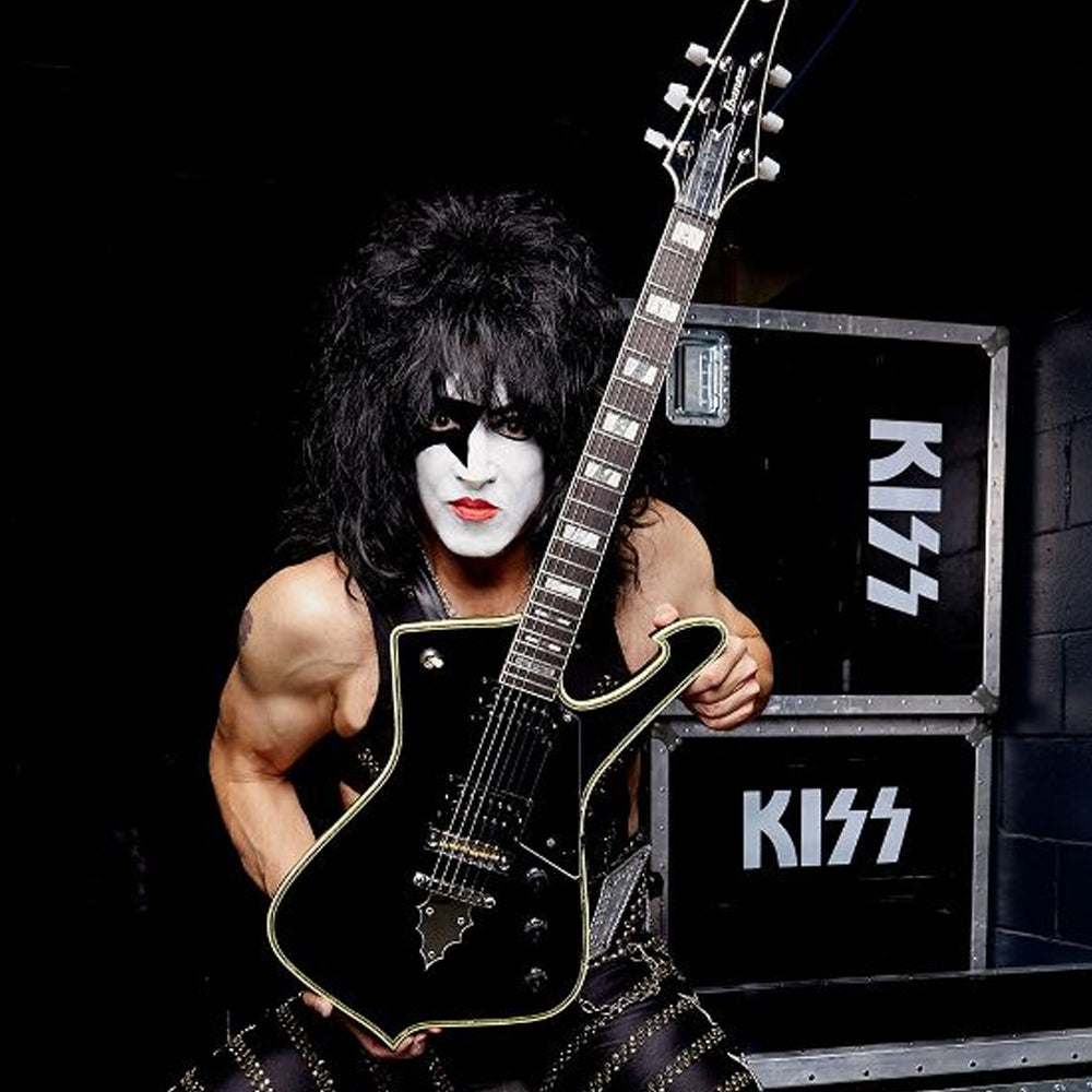 KISS musician holding up Ibanez electric guitar