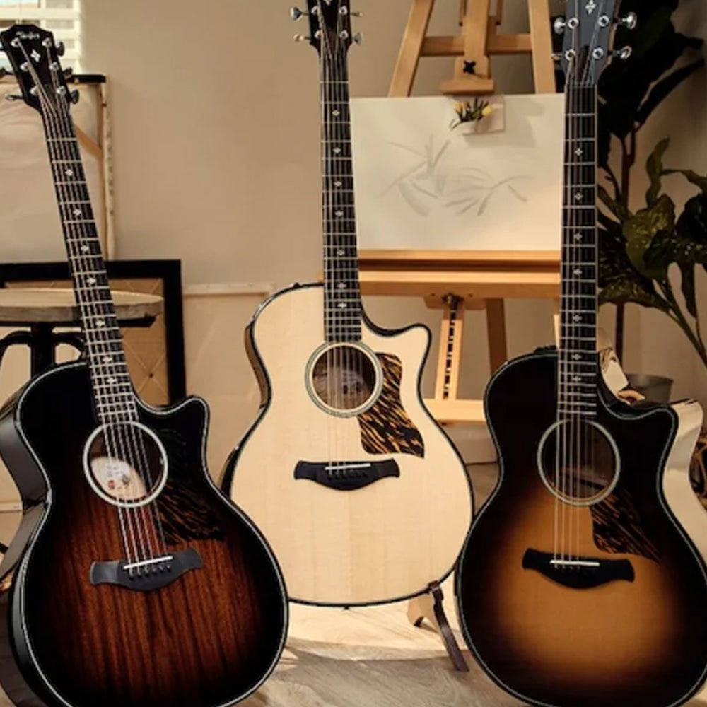 three Taylor acoustic guitars in a quaint music and arts room