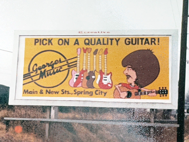 Vintage George’s Music billboard advertising guitars in Spring City