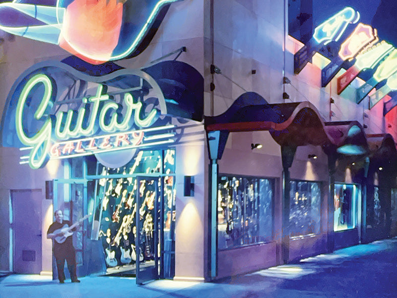 Neon Guitar Gallery storefront at night with guitars displayed inside