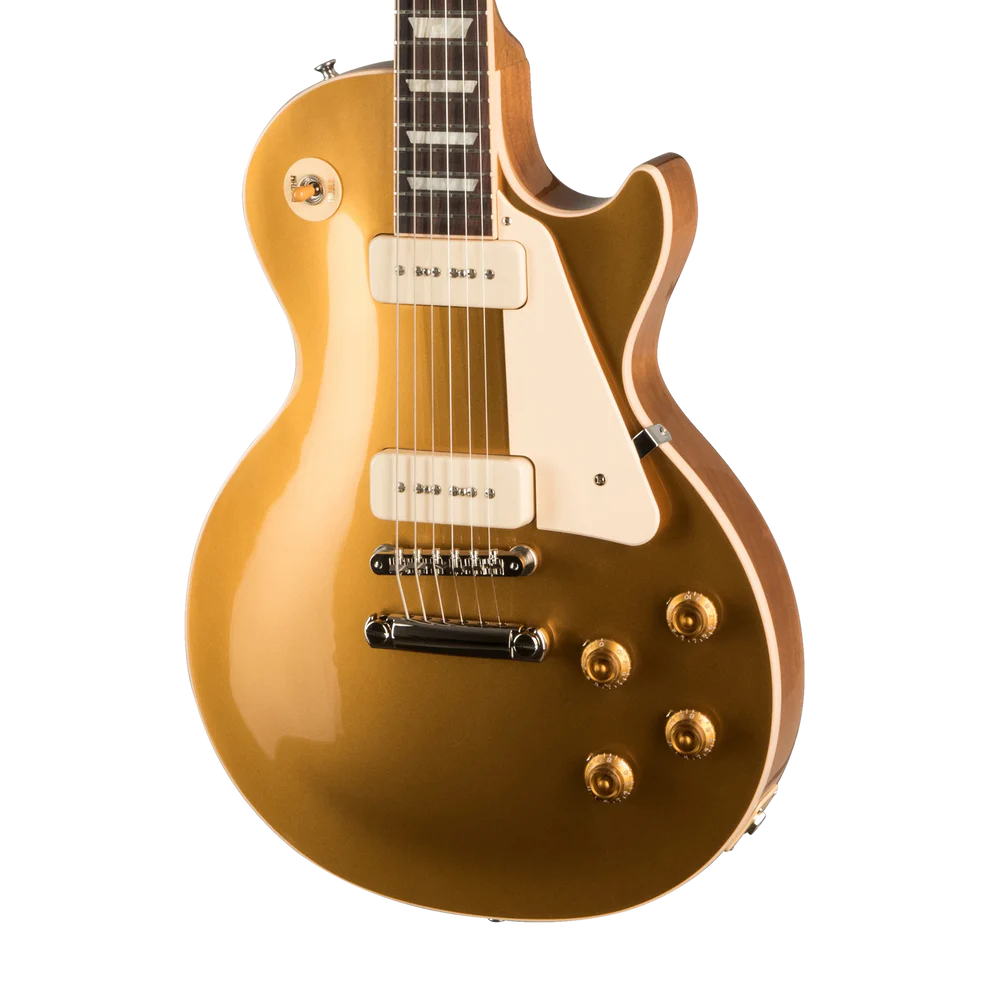 A gold-finish electric guitar with cream pickguard and hardware, shown from a side angle
