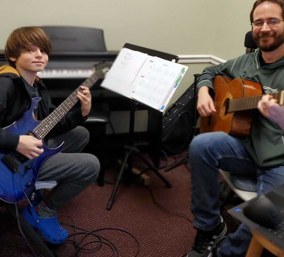 Geroge's Music guitar lesson with teacher and student