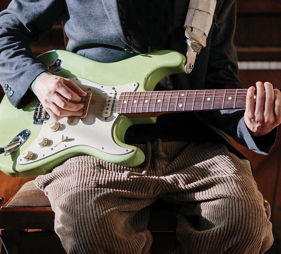 Person playing electric guitar during a lesson