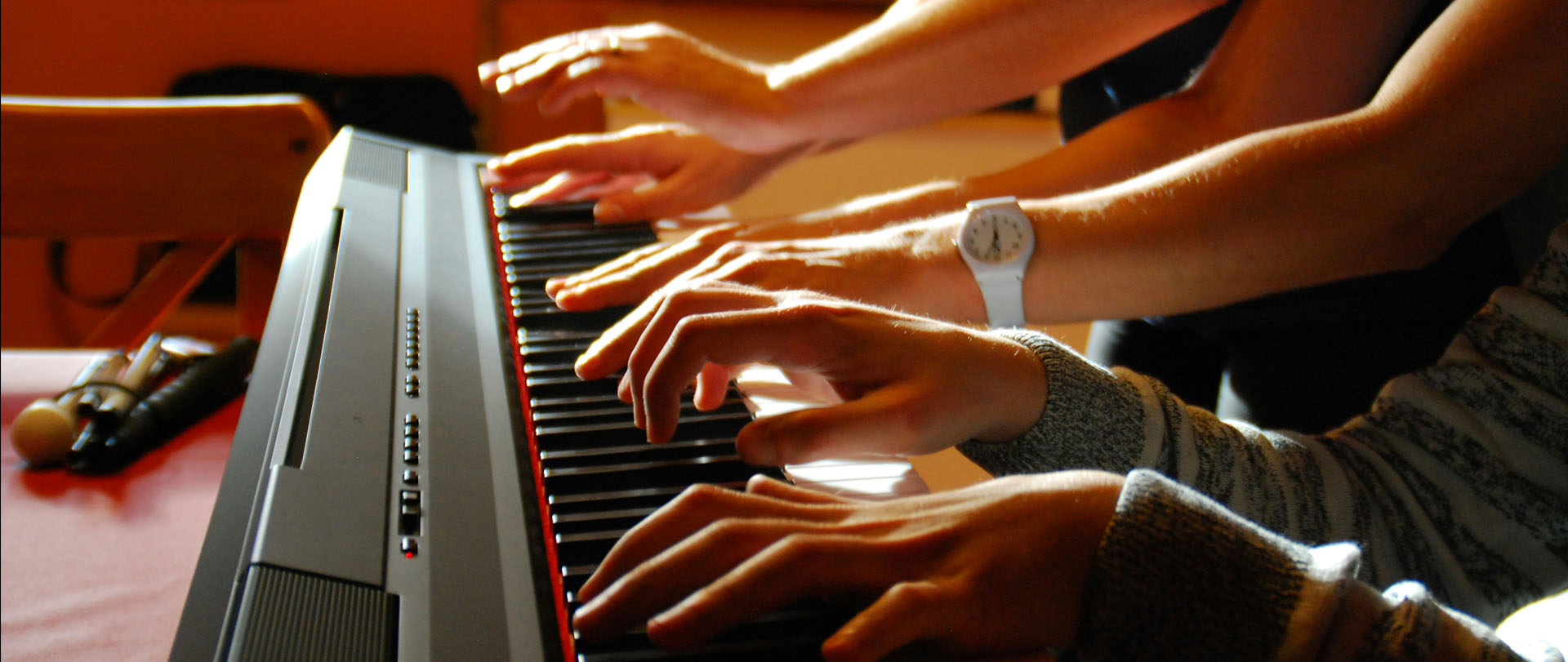 Close-up of hands playing a keyboard during a lesson