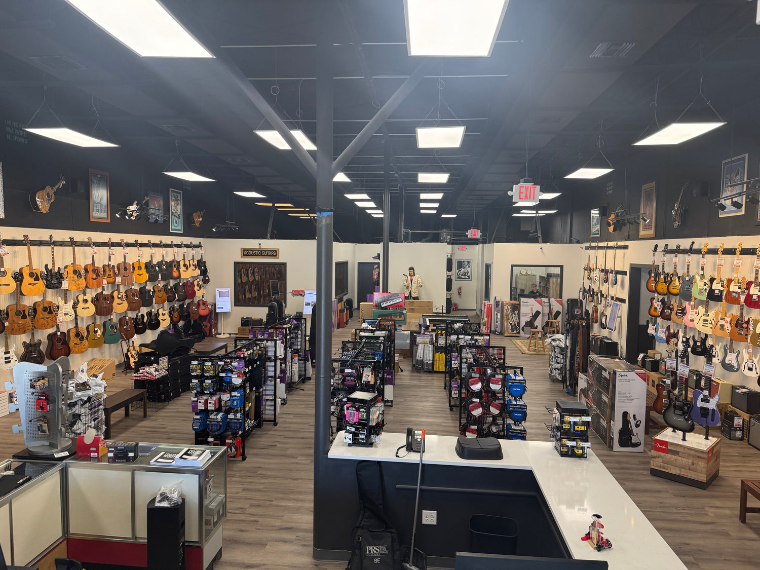 Wide view of retail showroom and guitar displays at George's Music Store in Jacksonville Beach, FL