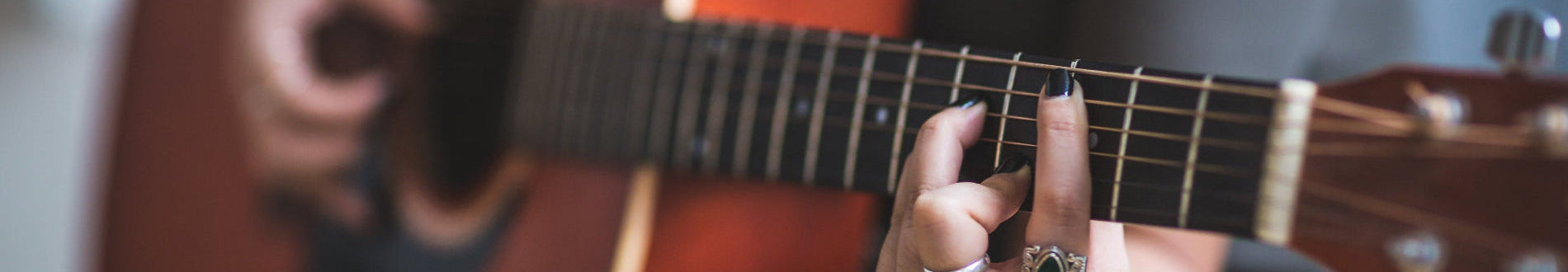 hands playing acoustic guitar